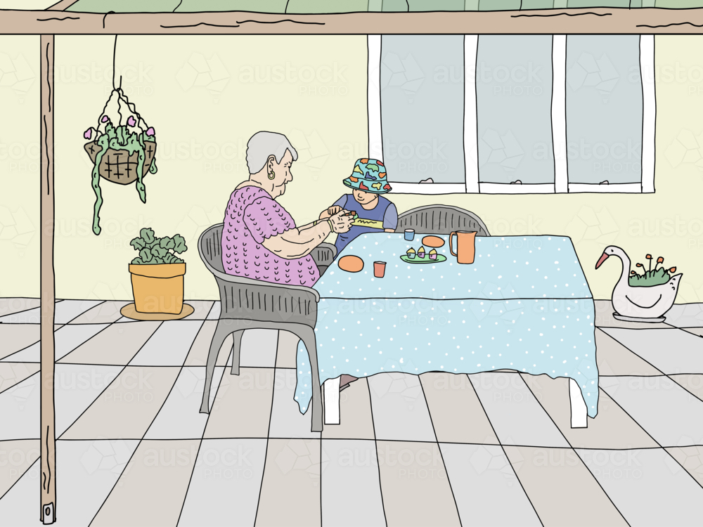 Old woman sharing morning tea with young boy at table under patio at home - Australian Stock Image