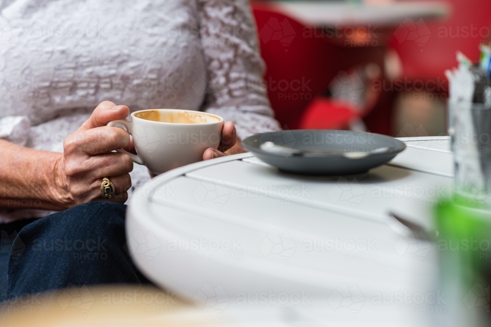 older woman with coffee cup - Australian Stock Image