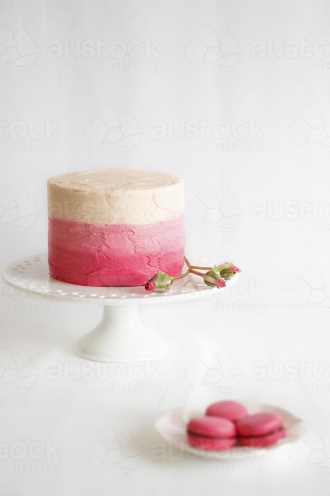 Ombre pink cake on cake stand - Australian Stock Image