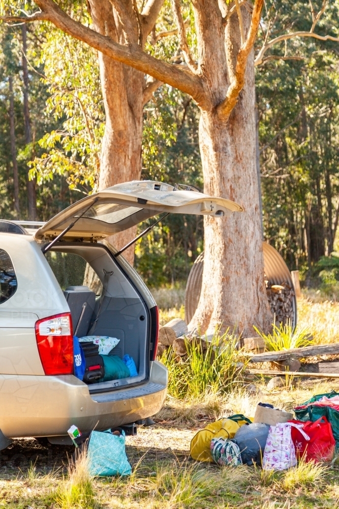 Open boot of car with bags in a pile for holidays - Australian Stock Image