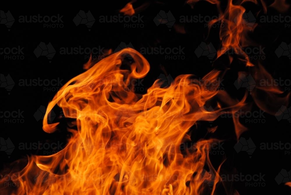 Orange fire flames flickering in the night - Australian Stock Image