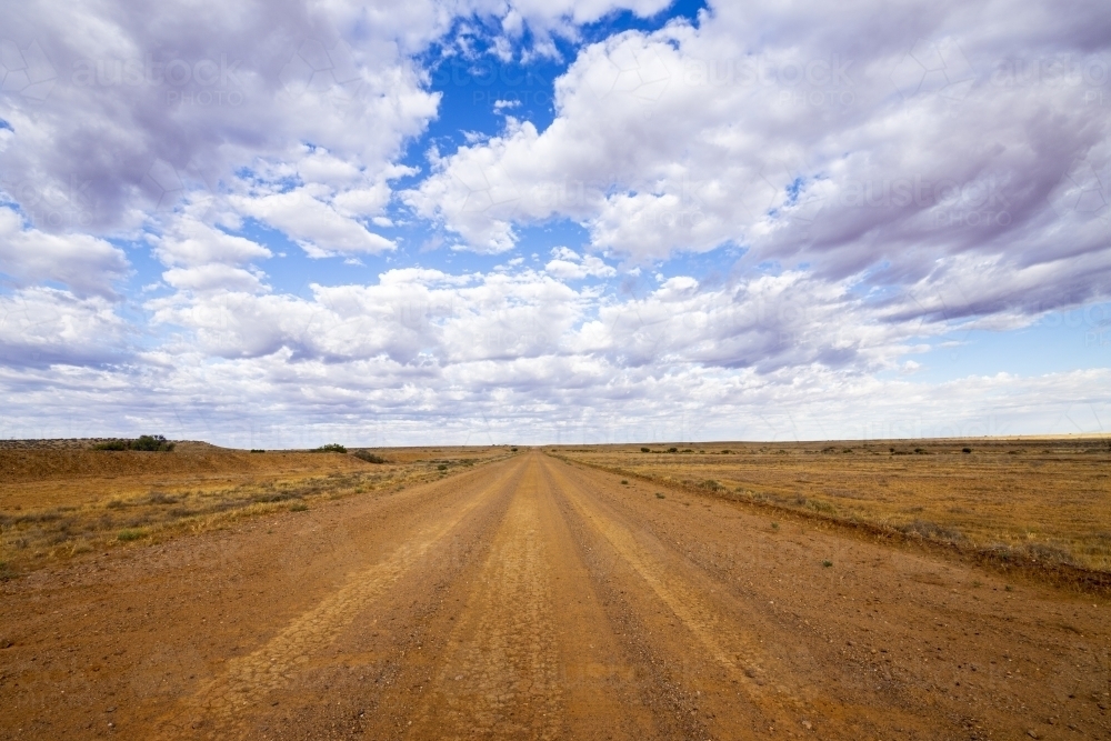 Outback road with cloudy sky - Australian Stock Image