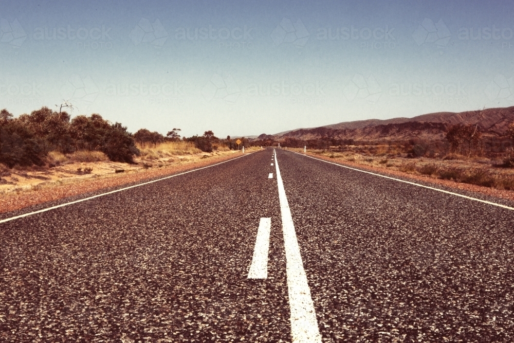 outback road with white lines on a hot day in a rural area - Australian Stock Image