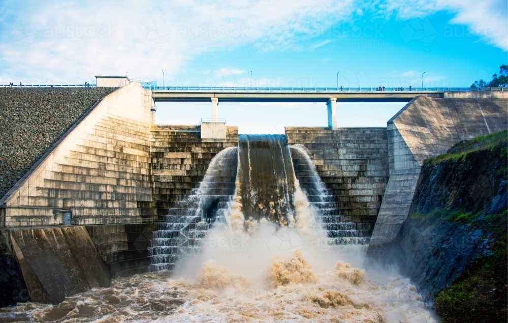 Overflowing weir with gushing water after floods - Australian Stock Image