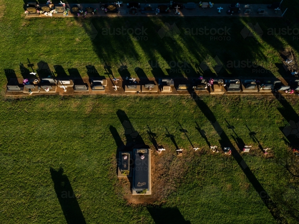 Overhead aerial view of cross shadows on grass at country graveyard - Australian Stock Image