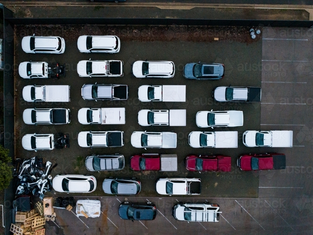 Overhead aerial view of full car lot with parked vehicles - Australian Stock Image