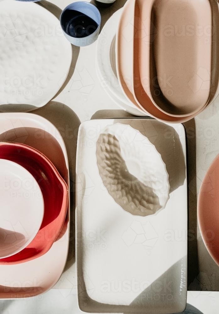 overhead of plates and cups with shadows - Australian Stock Image