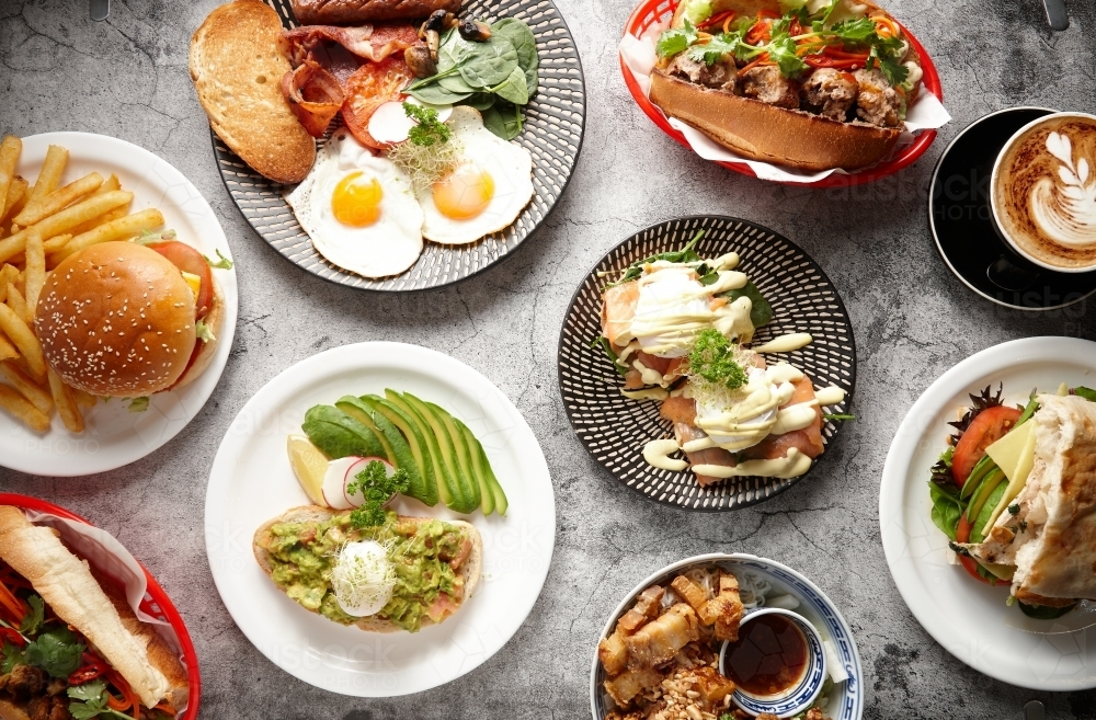 Overhead shot of different food dishes on a flat surface. - Australian Stock Image