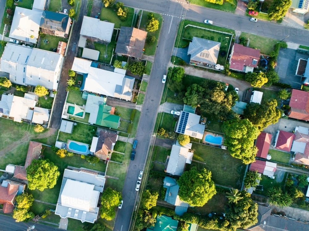 overhead view of houses along street in town - Australian Stock Image