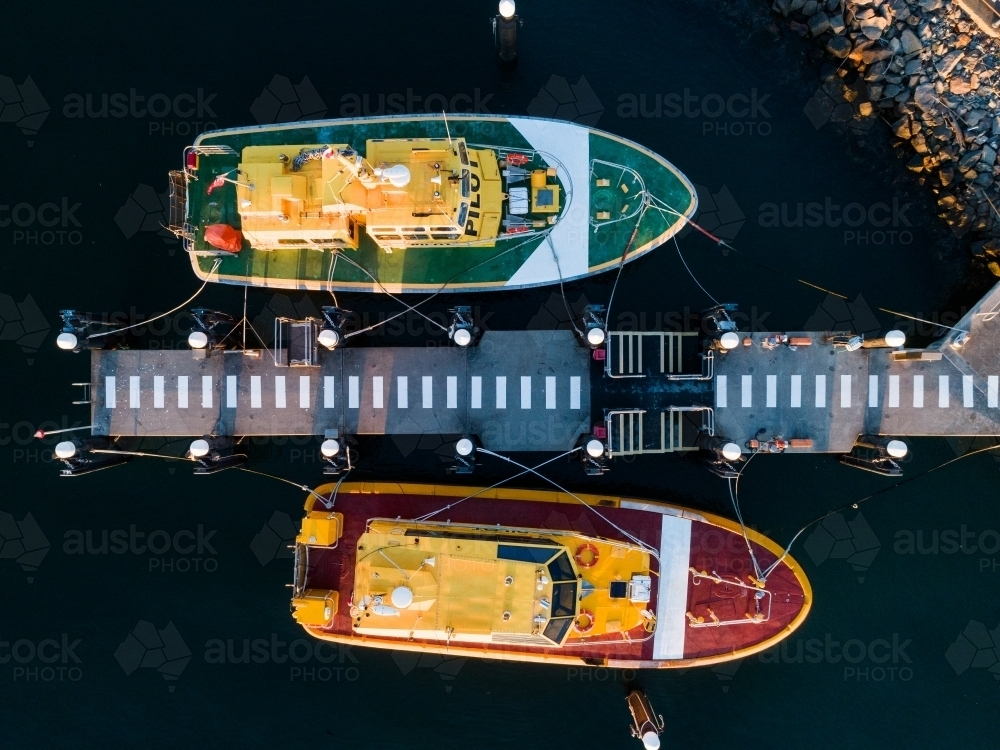 Overhead view of red and green port authority boats at Jetty on foreshore  - Australian Stock Image