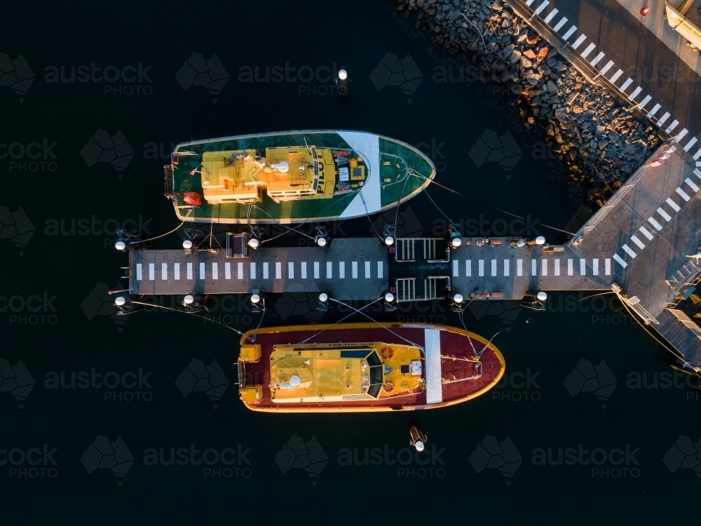 Overhead view of red and green port authority boats at Jetty on foreshore  - Australian Stock Image