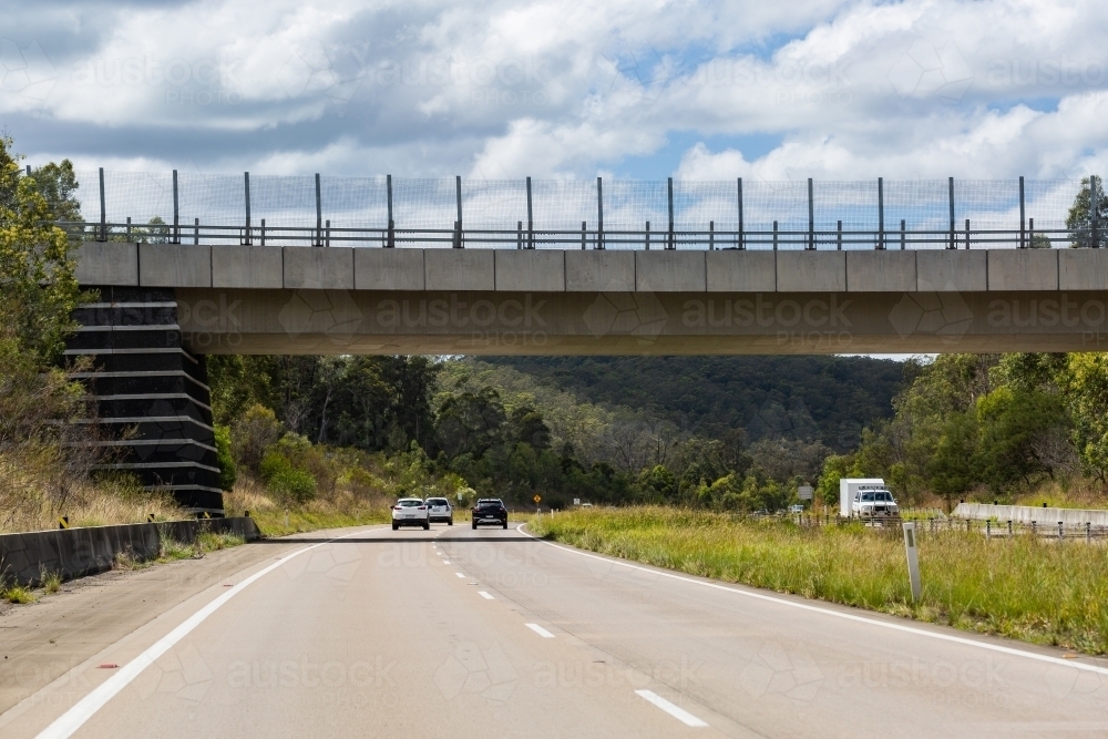 overpass with highway road running under it - Australian Stock Image