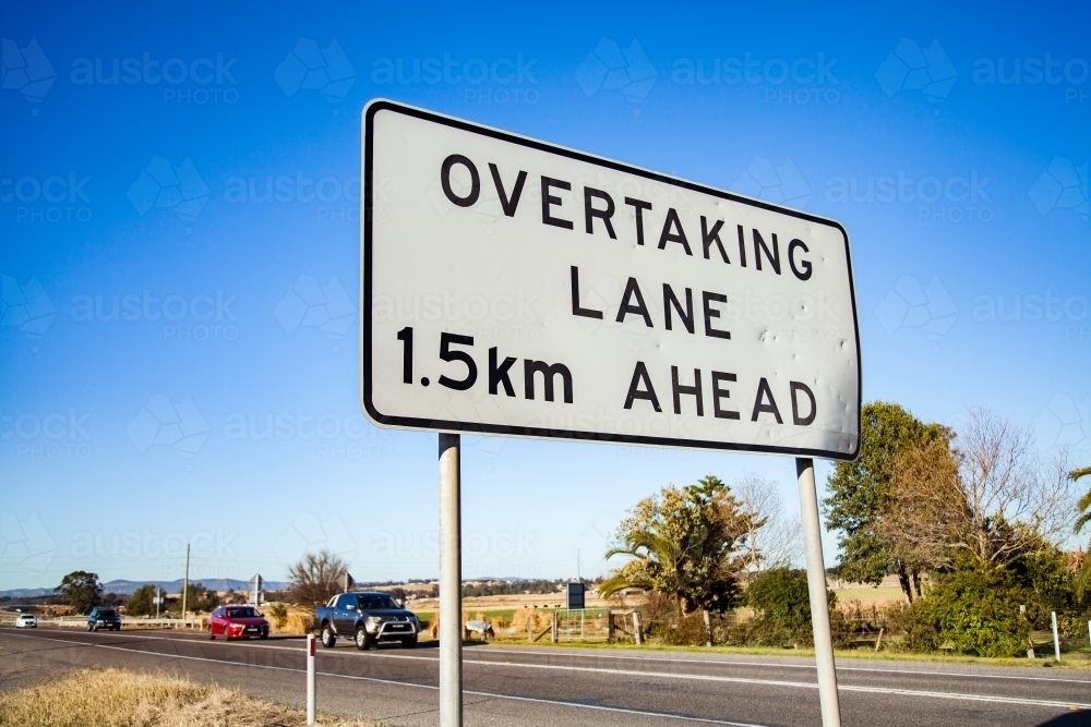 Overtaking lane 1.5 km ahead sign beside the road - Australian Stock Image