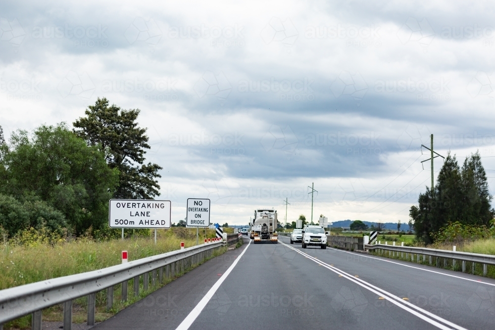 Overtaking lane ahead with no overtaking or passing sign at narrow road - Australian Stock Image