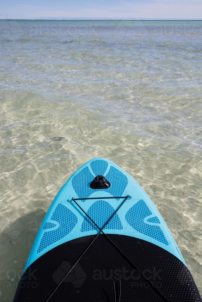 Paddling across crystal clear waters - Australian Stock Image