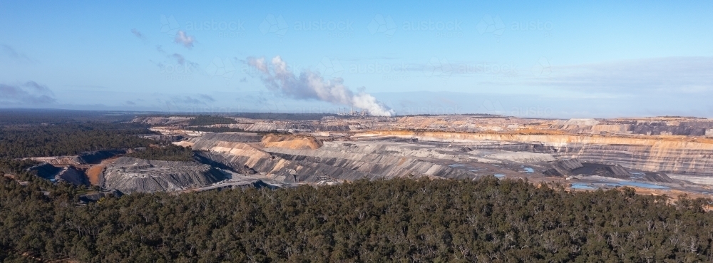 panoramic image of open cut coal mine and power station in distance - Australian Stock Image