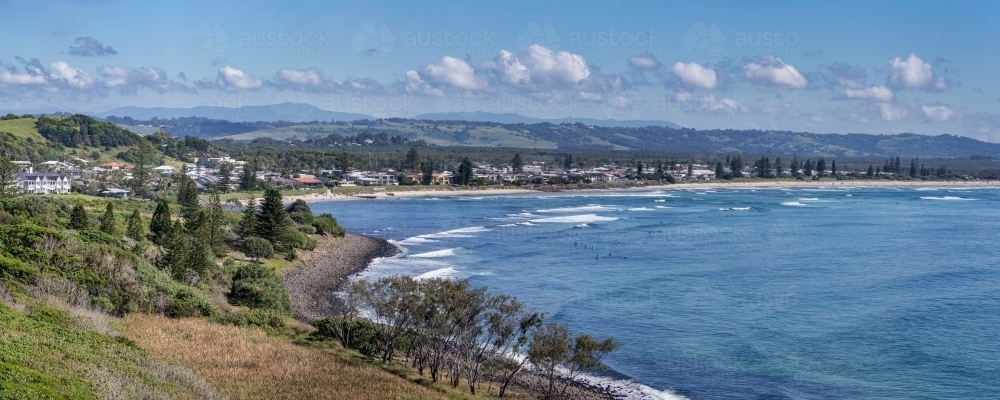 Panoramic view of coastal town along coastline, with sandy beach - Australian Stock Image