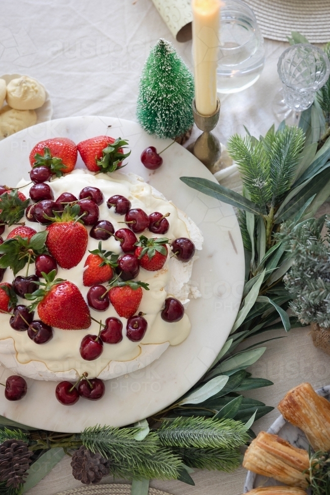 Pavlova on decorated Christmas table - Australian Stock Image