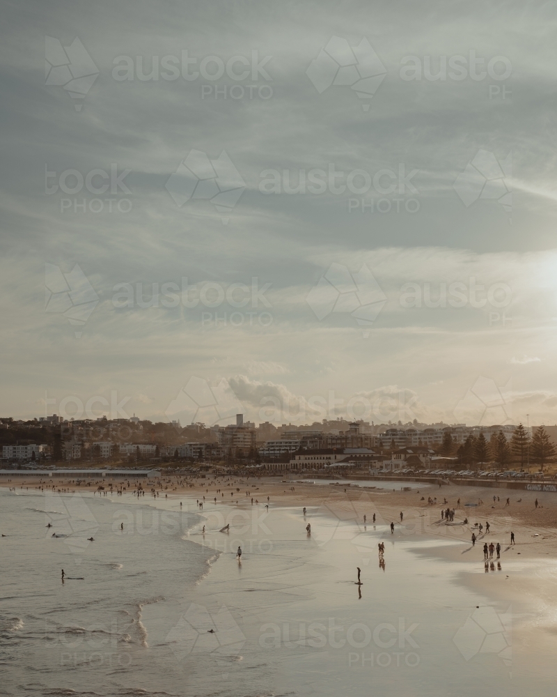 People enjoying a hazy sunset at Bondi Beach. - Australian Stock Image