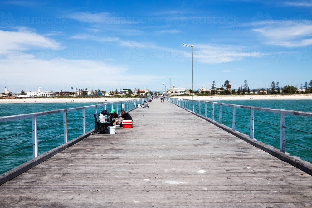 People fishing from jetty on a summer day - Australian Stock Image