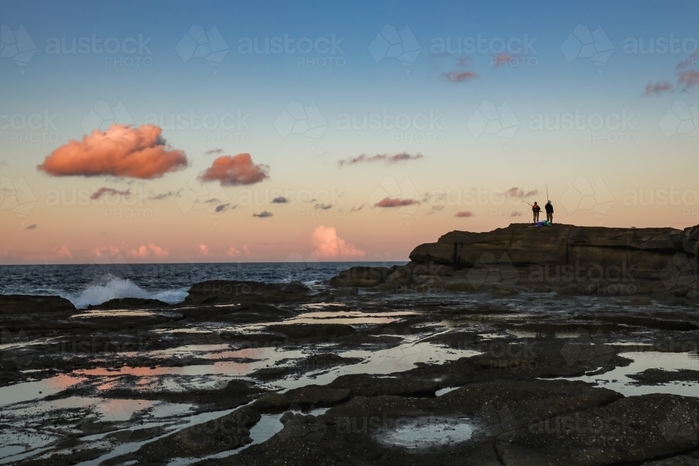 People fishing from rocks at Norah Head, New South Wales Australia - Australian Stock Image