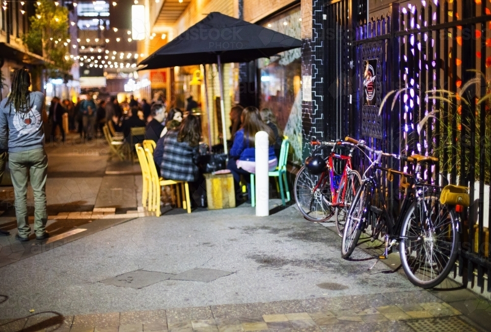 People in laneway restaurant at night - Australian Stock Image