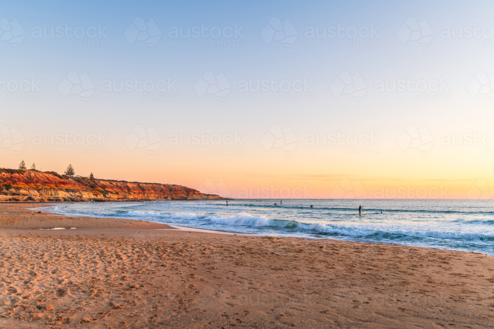 People surfing and paddleboarding at Southport beach, Port Noarlunga, South Australia - Australian Stock Image