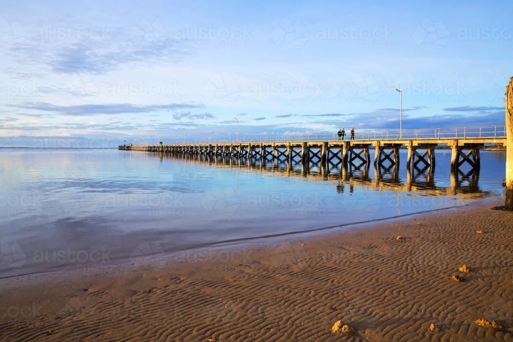 People walking along jetty late afternoon - Australian Stock Image