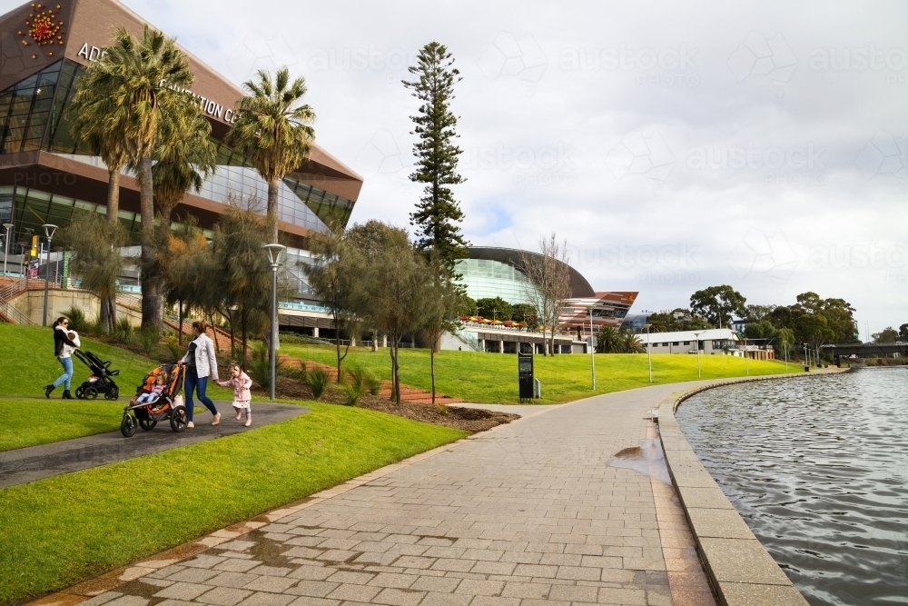People walking along riverbank area - Australian Stock Image