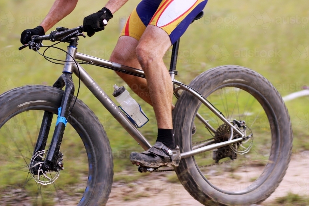 Person riding push bike on mountain bike track in the bush - Australian Stock Image