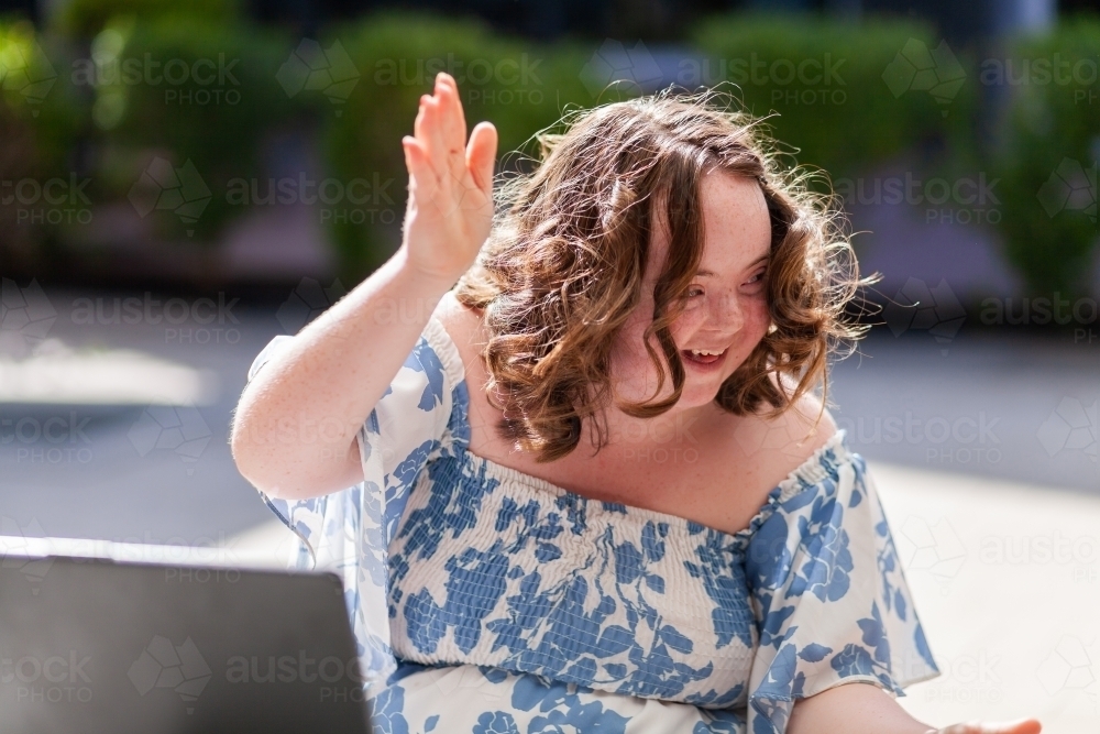 Person with down syndrome clapping and moving in happy way - Australian Stock Image