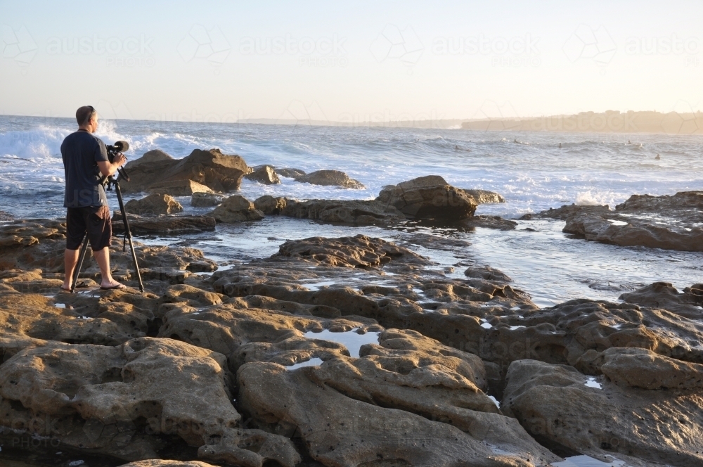 Photographer on rocks - Australian Stock Image