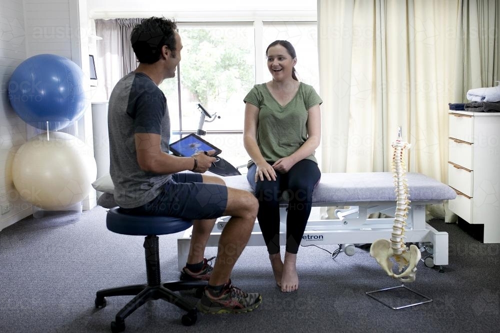 Physiotherapist in consultation with patient - Australian Stock Image