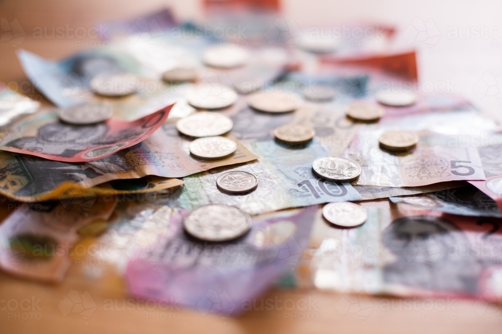 pile of Australian money spread out on a table - Australian Stock Image