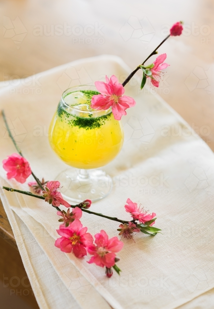 Pink cherry blossoms and cocktail with napkin - Australian Stock Image