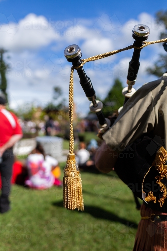 Pipes of bagpipe musician playing during ANZAC Day ceremony - Australian Stock Image