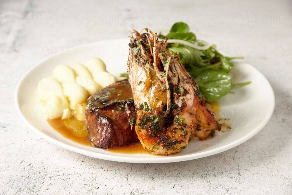 Plate of surf n turf - steak and prawns - Australian Stock Image