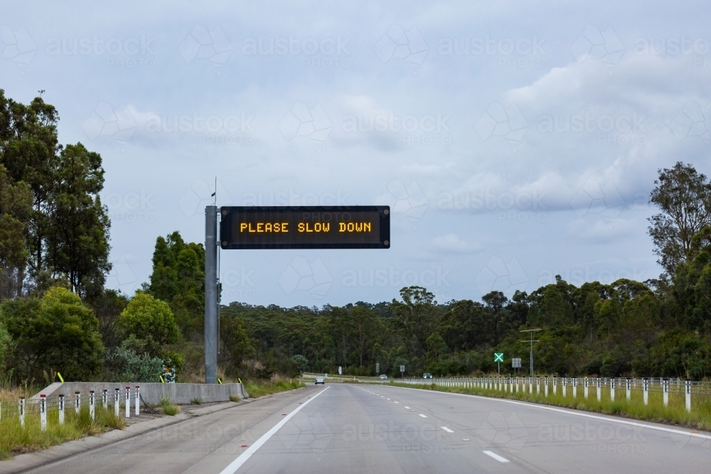 Pleas slow down digital road sign above highway in NSW - Australian Stock Image