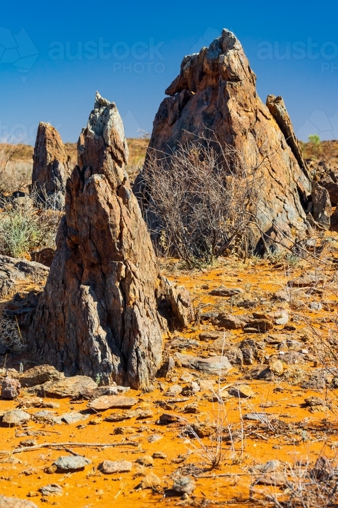 Pointed rock formation in an arid outback landscape - Australian Stock Image