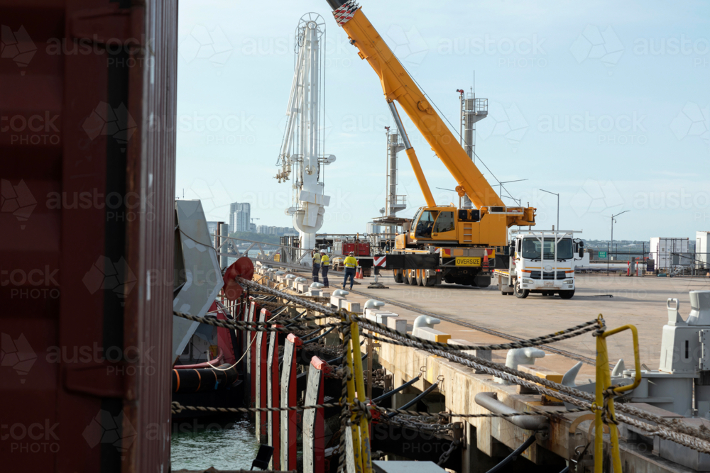 Port loading with crane and workmen - Australian Stock Image