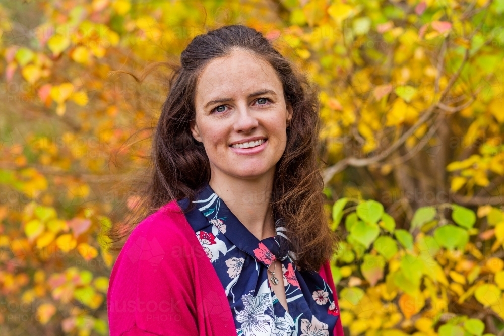 Portrait of a happy brunette australian woman in autumn - Australian Stock Image