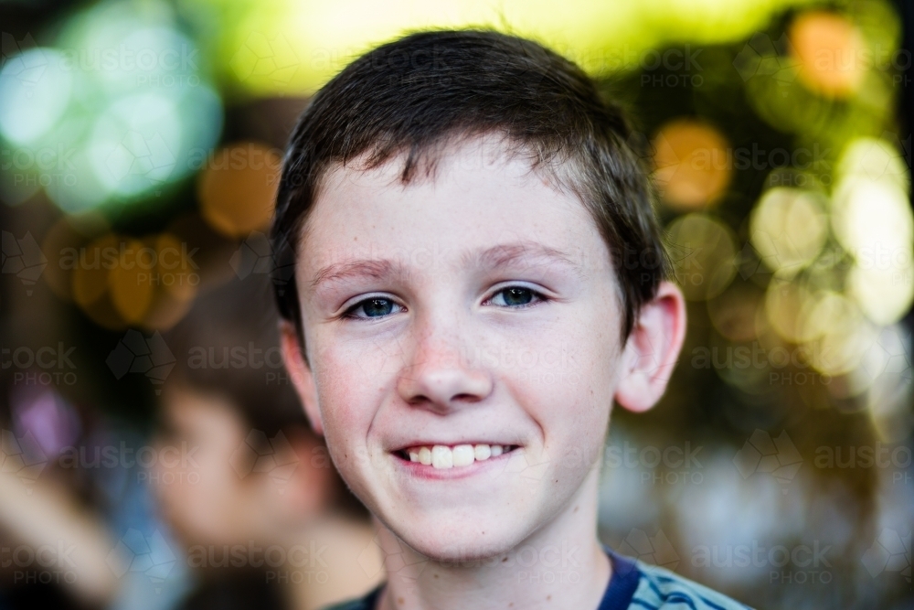 Portrait of a happy eleven year old boy with blurred background - Australian Stock Image