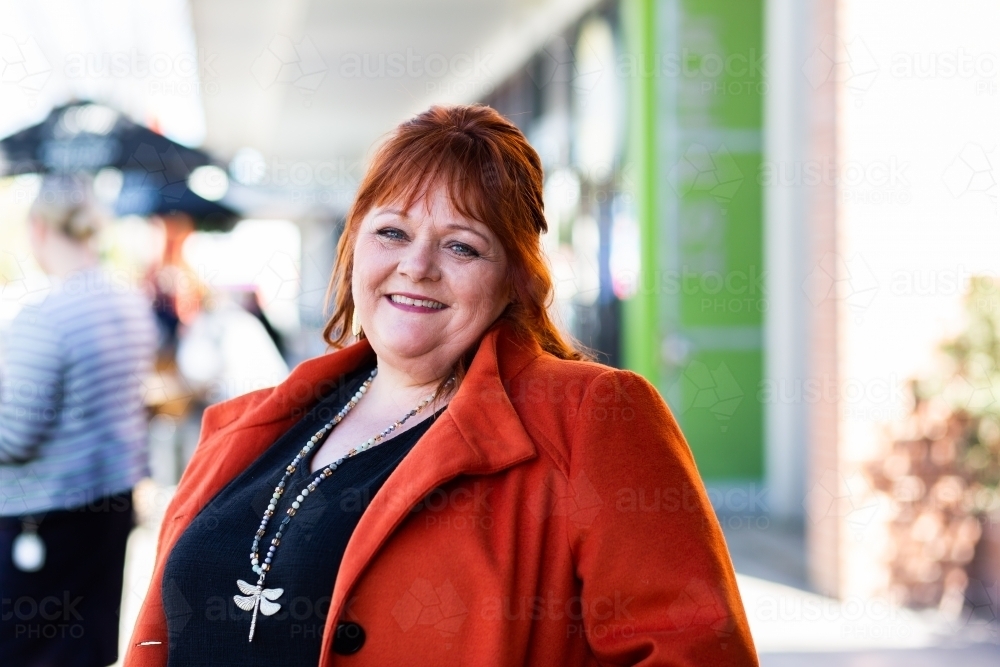 Portrait of a happy middle age lady in urban setting - Australian Stock Image