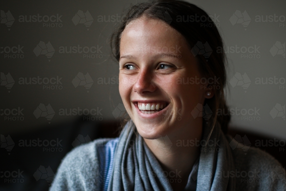 Portrait of a happy young teenage girl indoors - Australian Stock Image