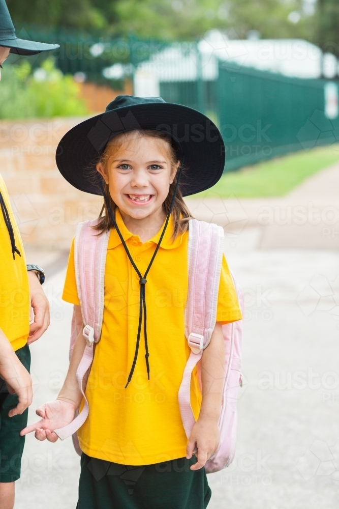 Portrait of a smiling young Australian school girl with bag ready to go back to school - Australian Stock Image