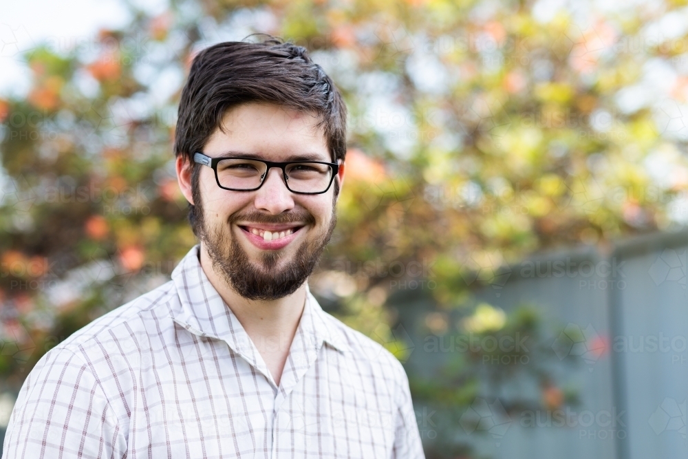 Portrait of a smiling young man in his twenties - Australian Stock Image