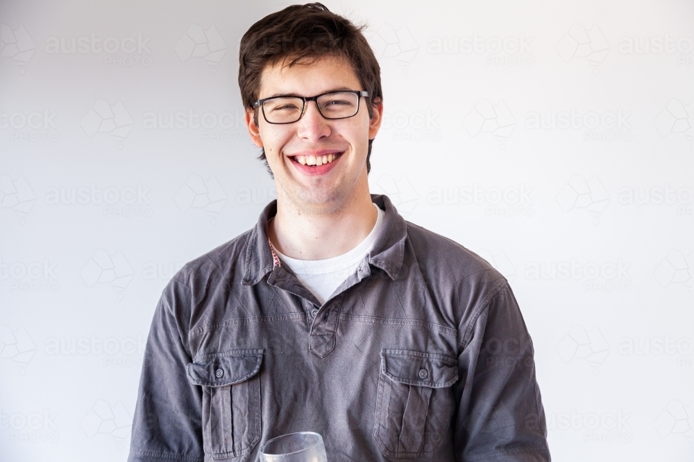 Portrait of a smiling young man on white - Australian Stock Image