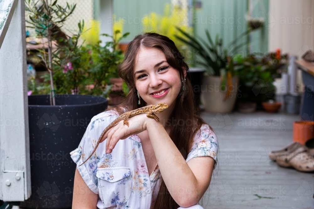 Portrait of a young adult lizard owner with pet reptile - Australian Stock Image