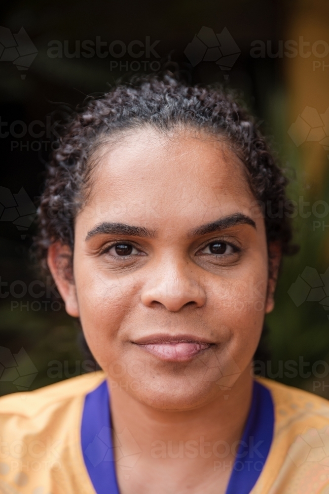 Portrait of Aboriginal woman looking at the camera - Australian Stock Image