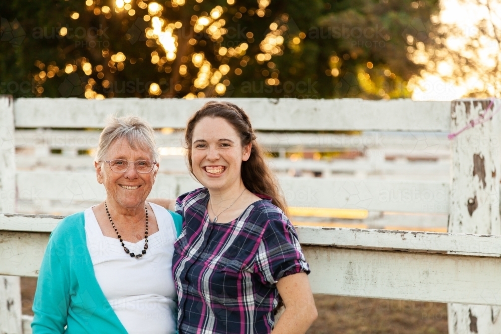 Portrait of adult grandchild with grandmother smiling together - Australian Stock Image